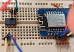 A breadboard with an SPI ROM chip connected to an ESP-8266 with jumper wires